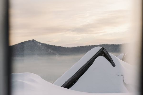 Person meditating outdoors at sunrise, symbolizing peace and renewal.